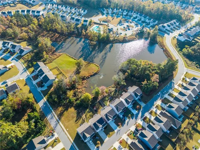 an aerial view of a house with a yard and lake view