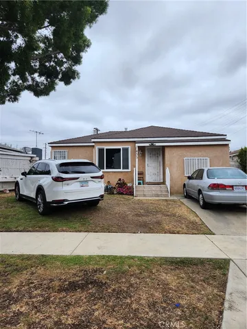 a couple of cars parked in front of a house
