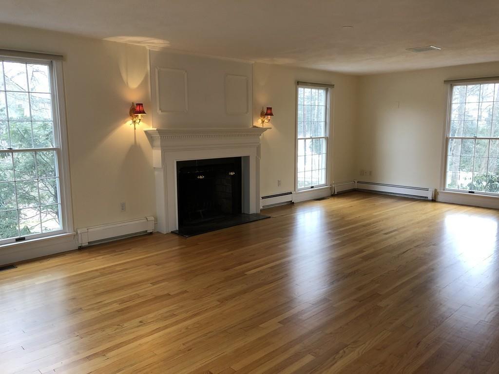 75 Old Farm Road Wellesley, MA 02481 - Photo 15 of 28 an empty room with wooden floor fireplace and windows