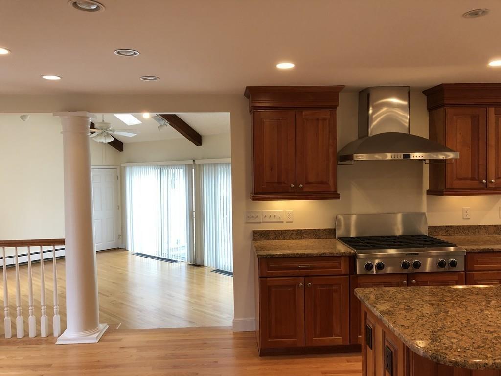 75 Old Farm Road Wellesley, MA 02481 - Photo 9 of 28 a kitchen with granite countertop a stove and a wooden cabinets