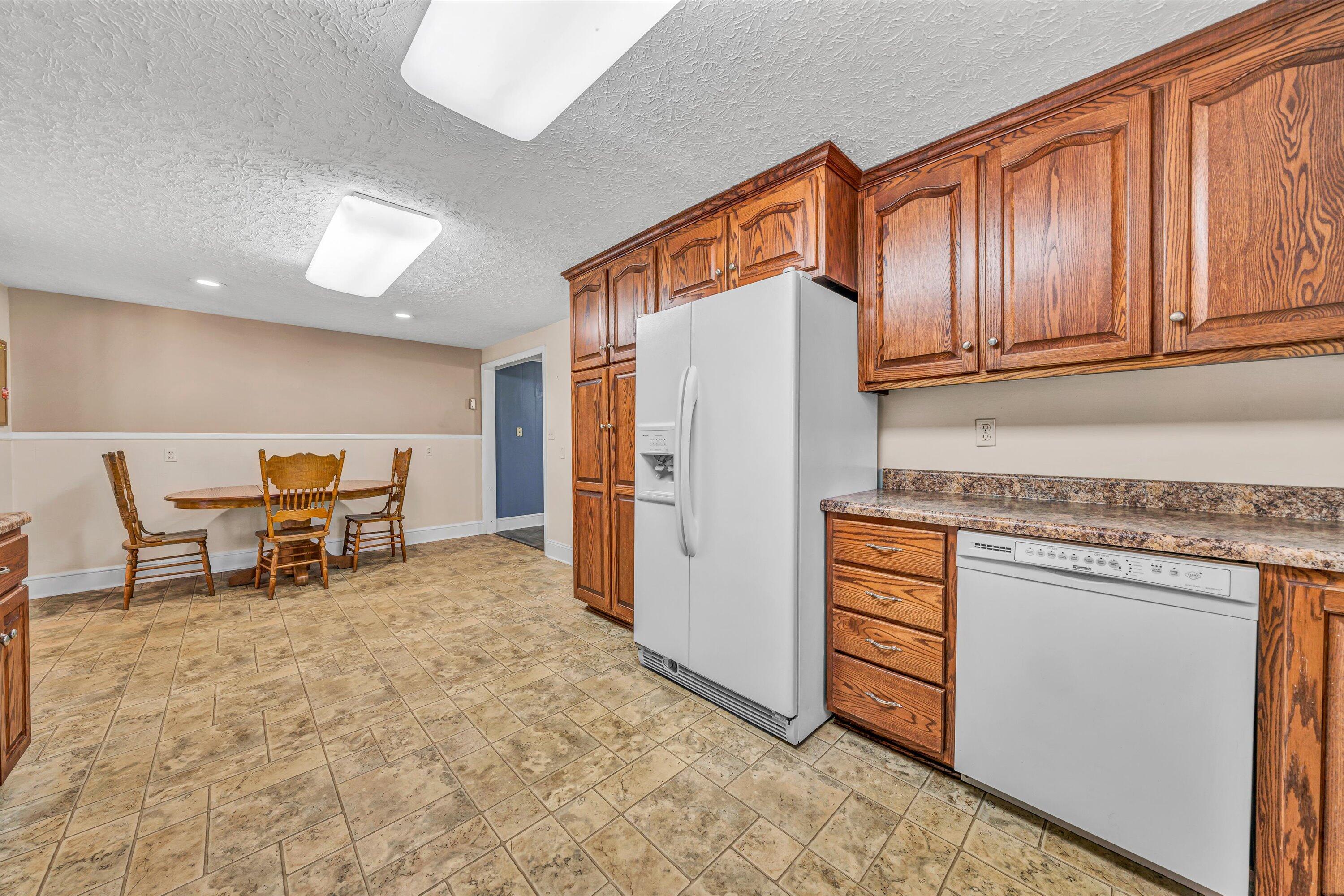 90 Campbellwood Road Boones Mill, VA 24065 - Photo 9 of 38 a kitchen with stainless steel appliances granite countertop a refrigerator and cabinets