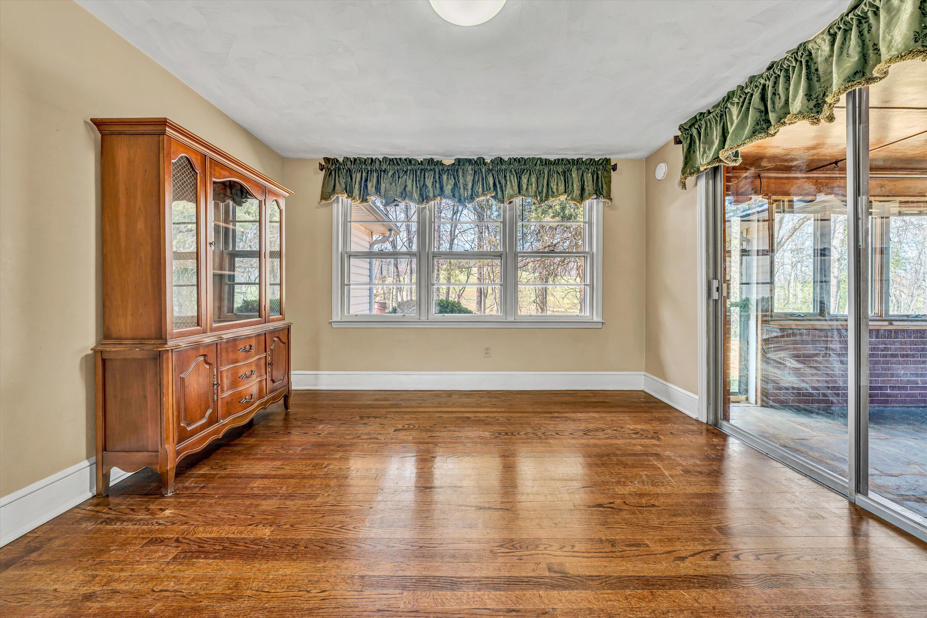 90 Campbellwood Road Boones Mill, VA 24065 - Photo 10 of 38 a view of an empty room with glass door and wooden floor