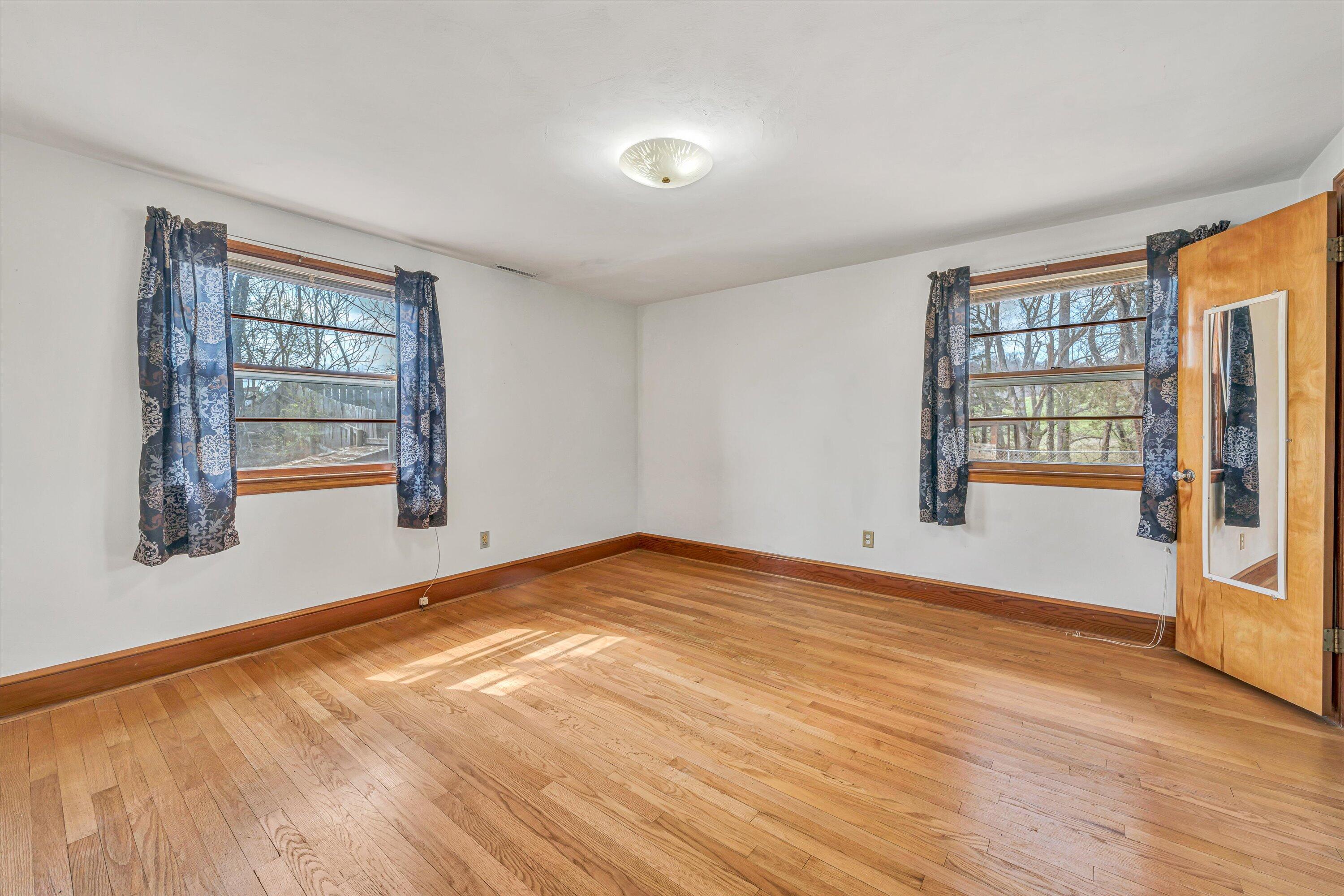 90 Campbellwood Road Boones Mill, VA 24065 - Photo 16 of 38 a view of an empty room with wooden floor and a window