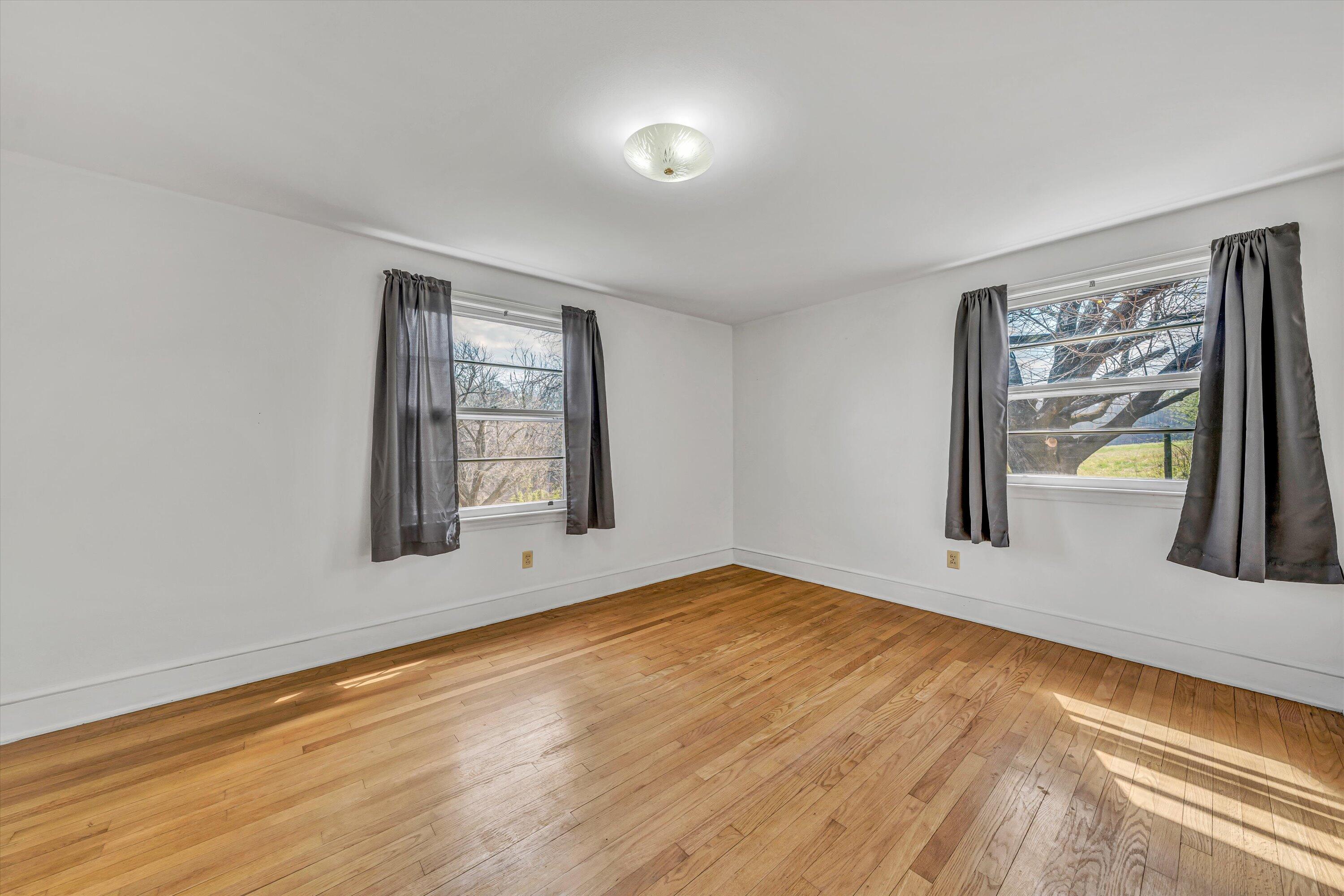 90 Campbellwood Road Boones Mill, VA 24065 - Photo 20 of 38 a view of an empty room with window and wooden floor