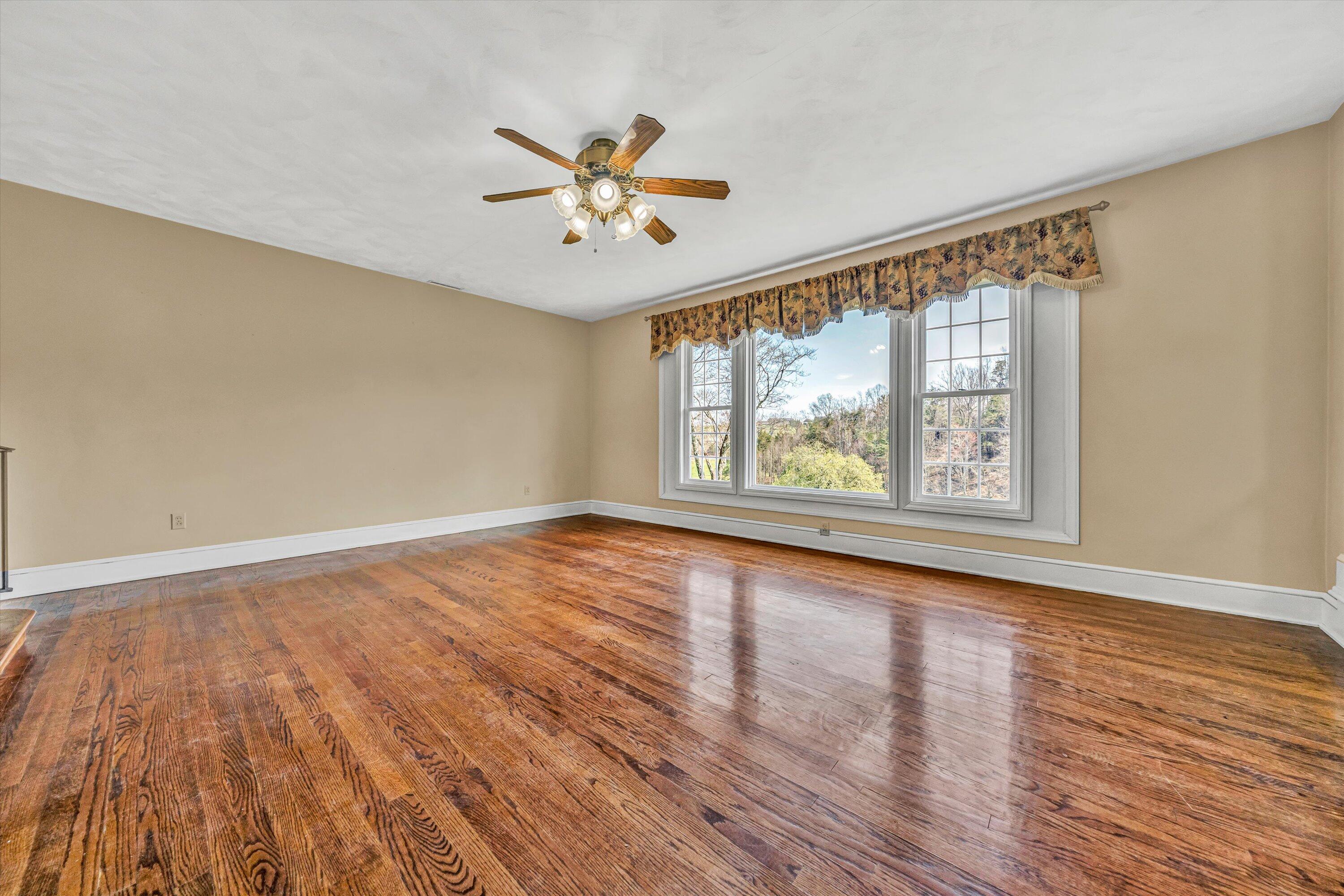 90 Campbellwood Road Boones Mill, VA 24065 - Photo 5 of 38 a view of an empty room with window and wooden floor