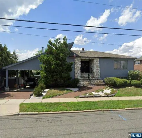 a view of house with a yard and potted plants