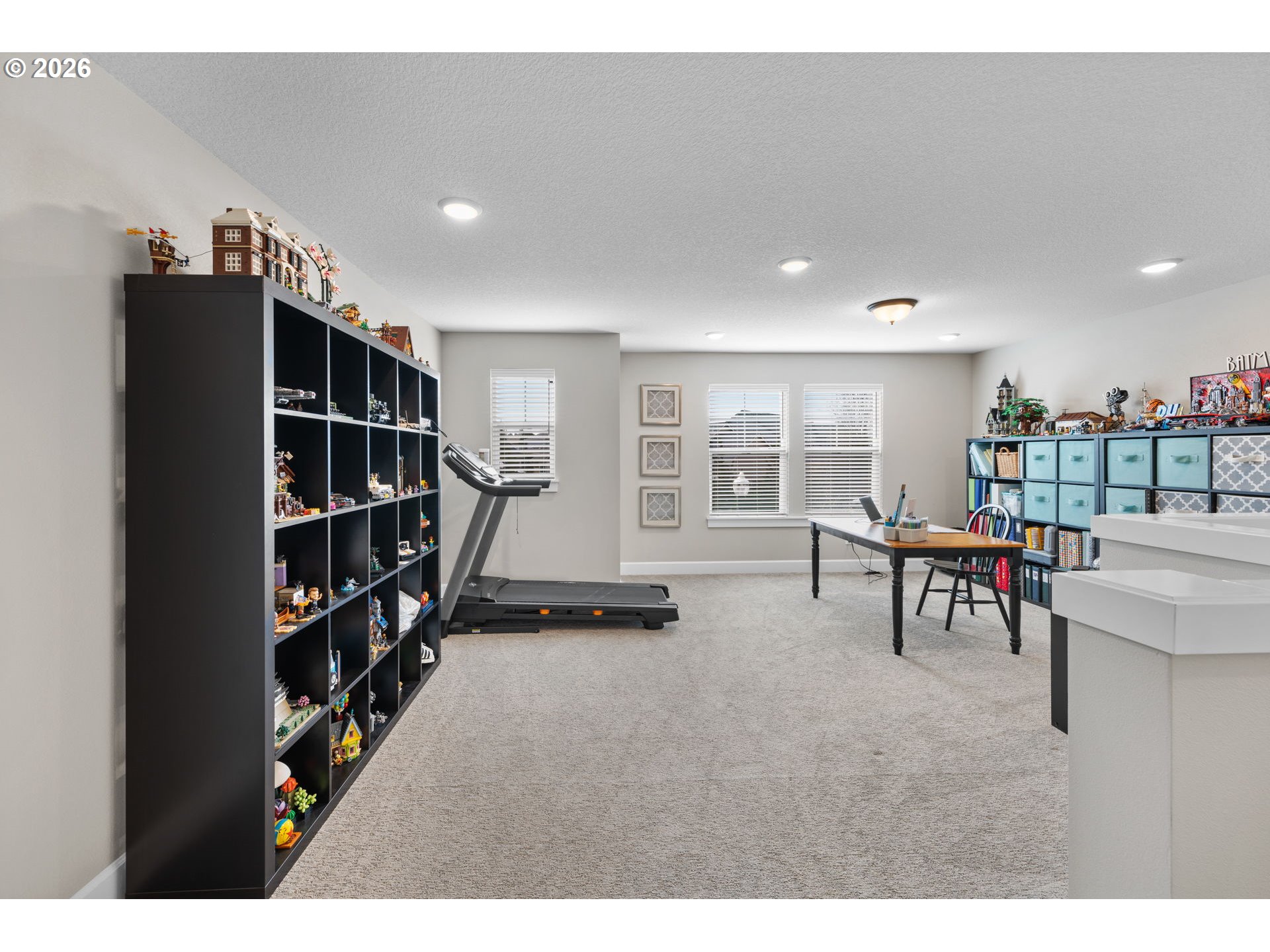 17311 Northeast 28th Court Ridgefield, WA 98642 - Photo 17 of 38 a living room with furniture a table and a bookshelf