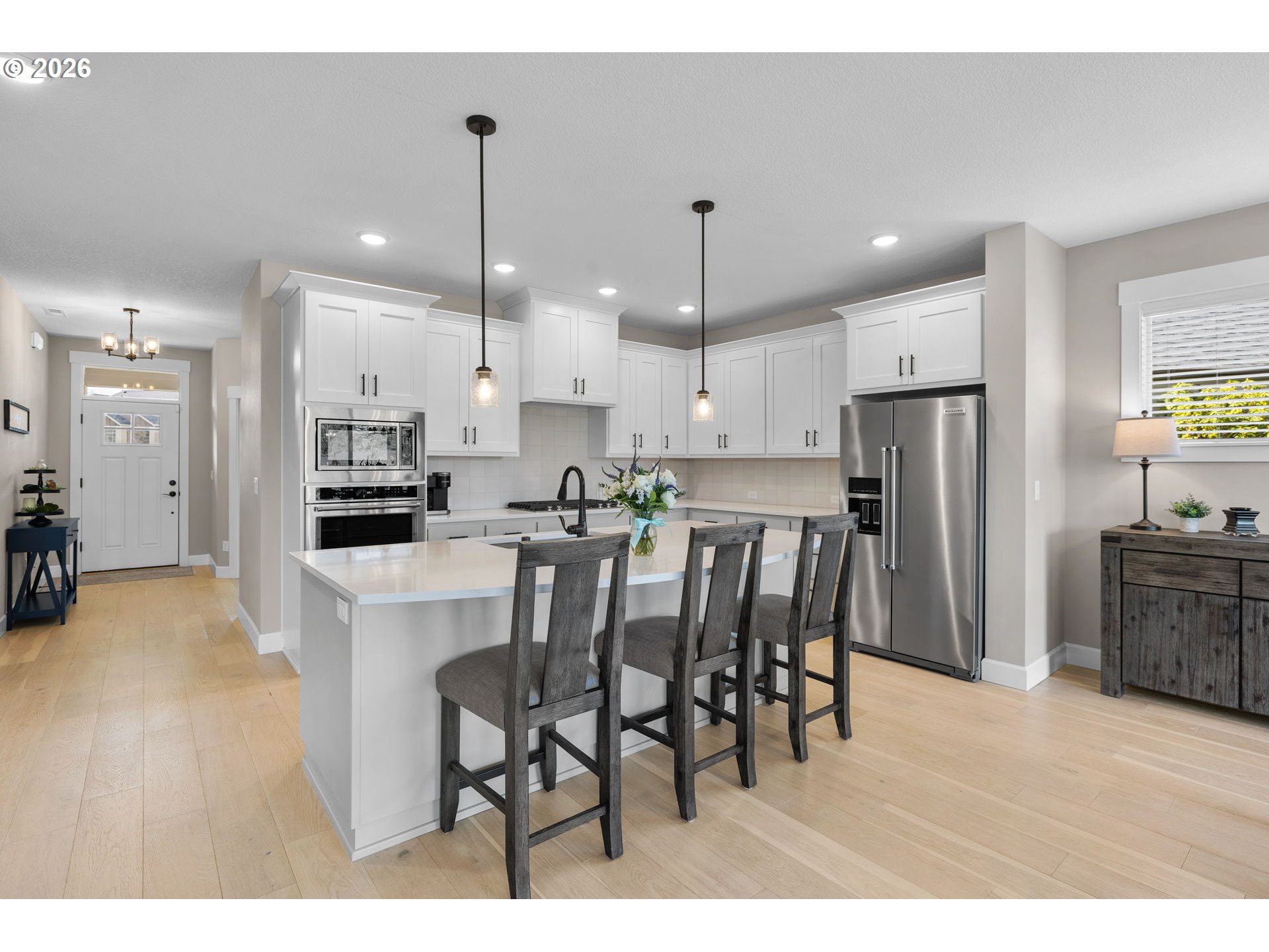17311 Northeast 28th Court Ridgefield, WA 98642 - Photo 6 of 38 a kitchen with stainless steel appliances kitchen island granite countertop a refrigerator and a stove top oven