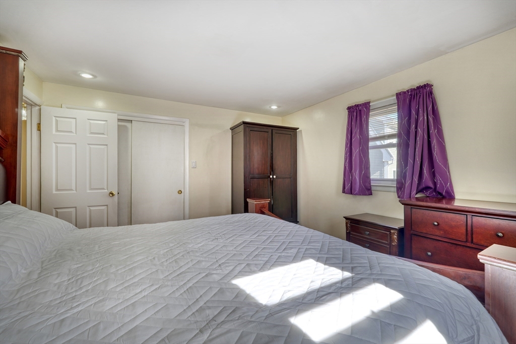 173 Overlook Road Arlington, MA 02474 - Photo 17 of 42 a bedroom with a large bed and wooden floor