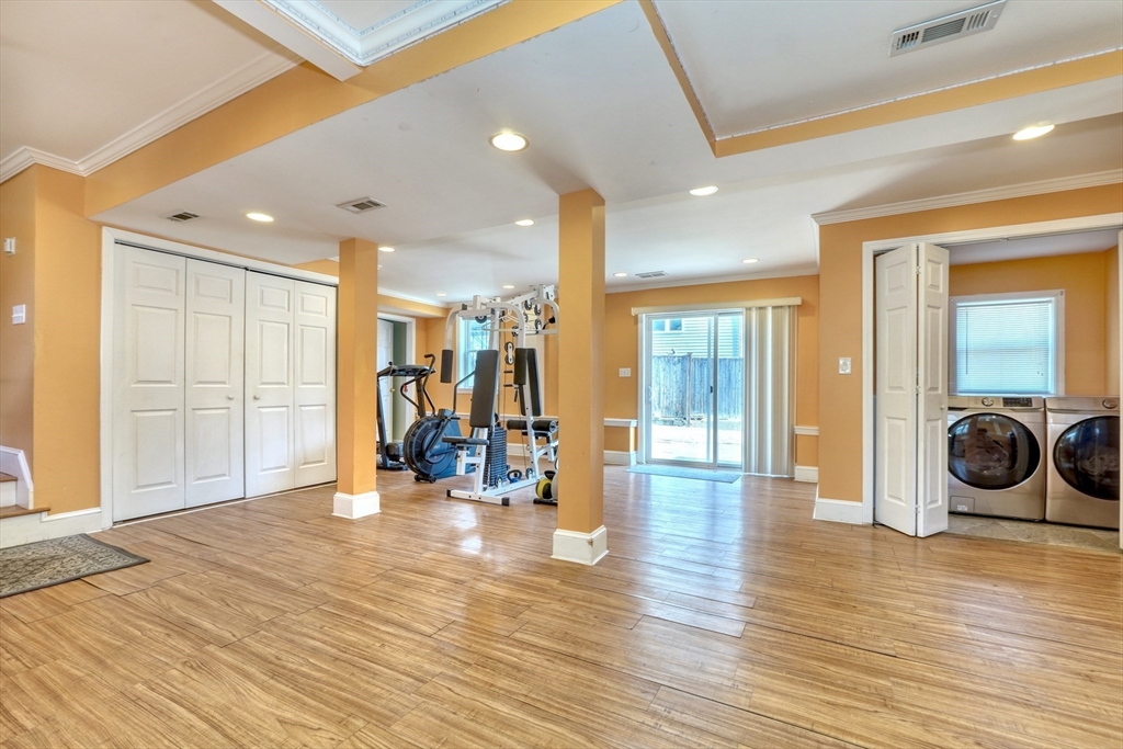 173 Overlook Road Arlington, MA 02474 - Photo 26 of 42 a view of a hallway with a living room and wooden floor
