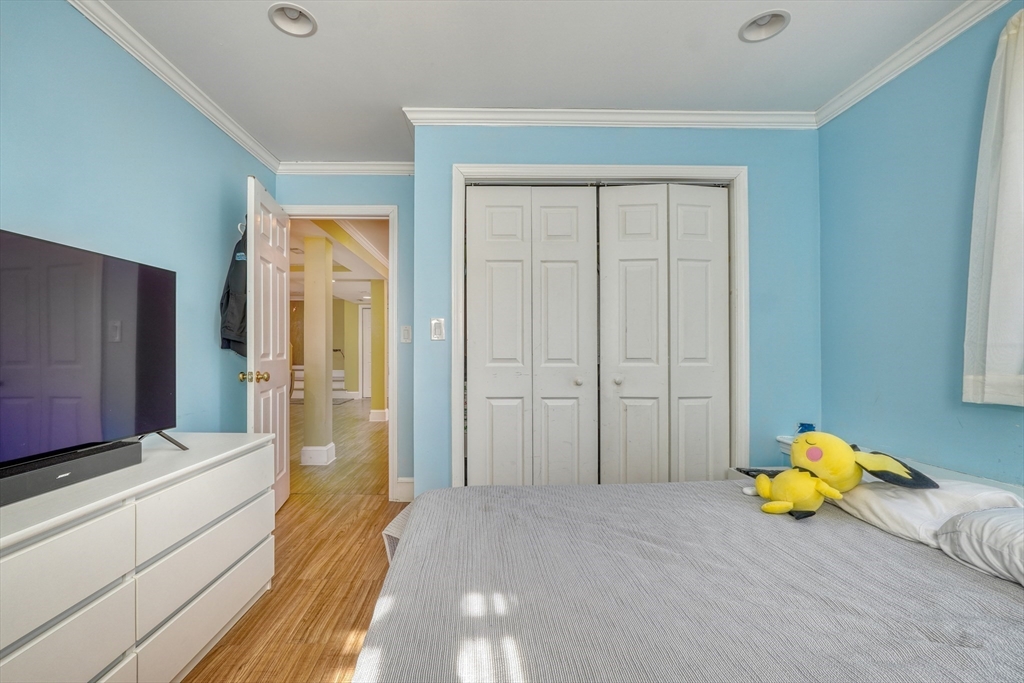 173 Overlook Road Arlington, MA 02474 - Photo 30 of 42 a view of a bedroom with a bed and wooden floor