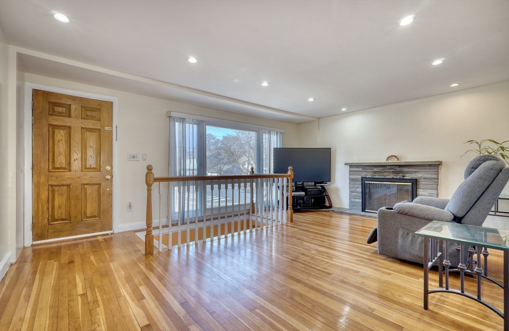 173 Overlook Road Arlington, MA 02474 - Photo 4 of 42 a view of a livingroom with furniture wooden floor windows and a fireplace