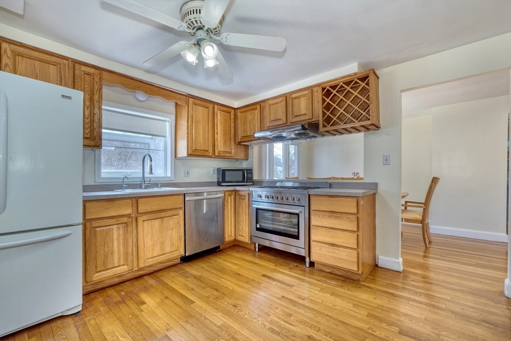 173 Overlook Road Arlington, MA 02474 - Photo 9 of 42 a kitchen with granite countertop a sink cabinets stainless steel appliances and a counter space