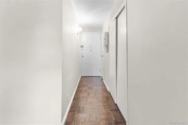 a view of a hallway with wooden floor