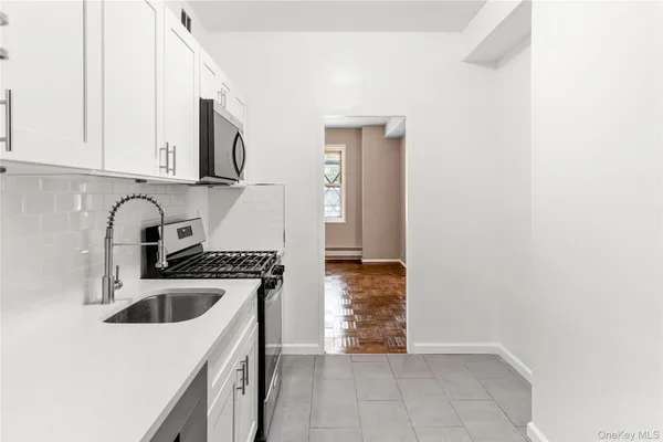 a kitchen with a sink a stove and cabinets