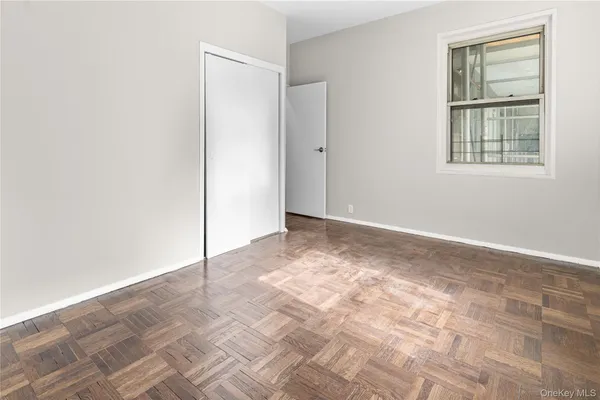 an empty room with windows and closet