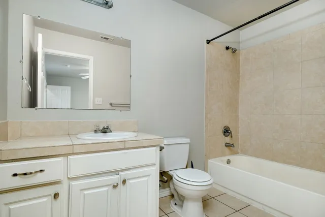 a bathroom with a sink toilet vanity and shower
