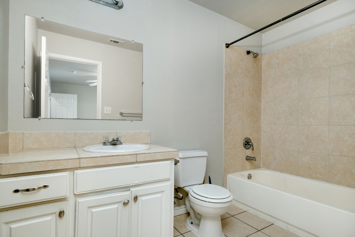 107 Castleberry Court, Unit C Bertram, TX 78605 - Photo 12 of 14 a bathroom with a sink toilet vanity and shower