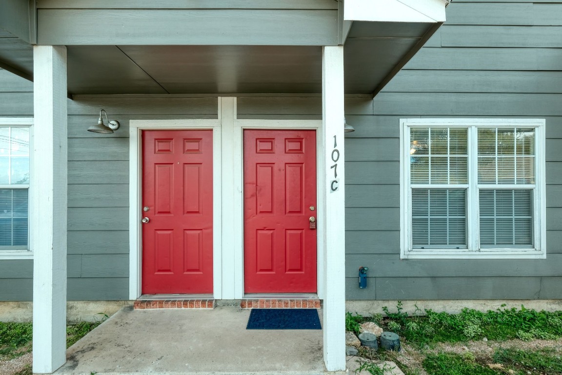 107 Castleberry Court, Unit C Bertram, TX 78605 - Photo 3 of 14 a house with red door