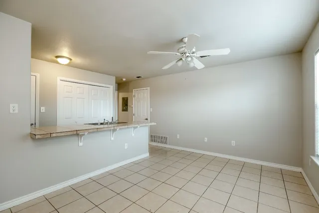 a view of a kitchen with a sink and chandelier fan