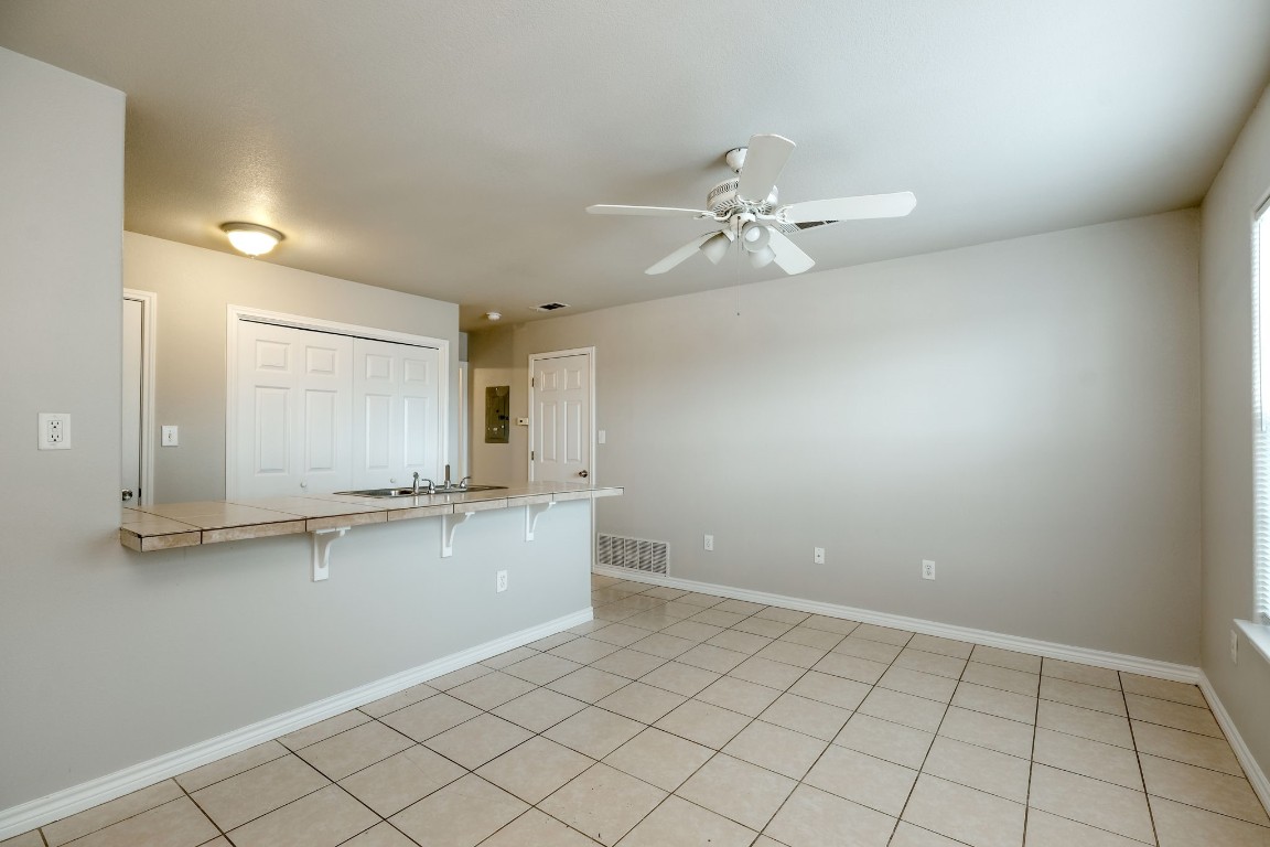 107 Castleberry Court, Unit C Bertram, TX 78605 - Photo 5 of 14 a view of a kitchen with a sink and chandelier fan