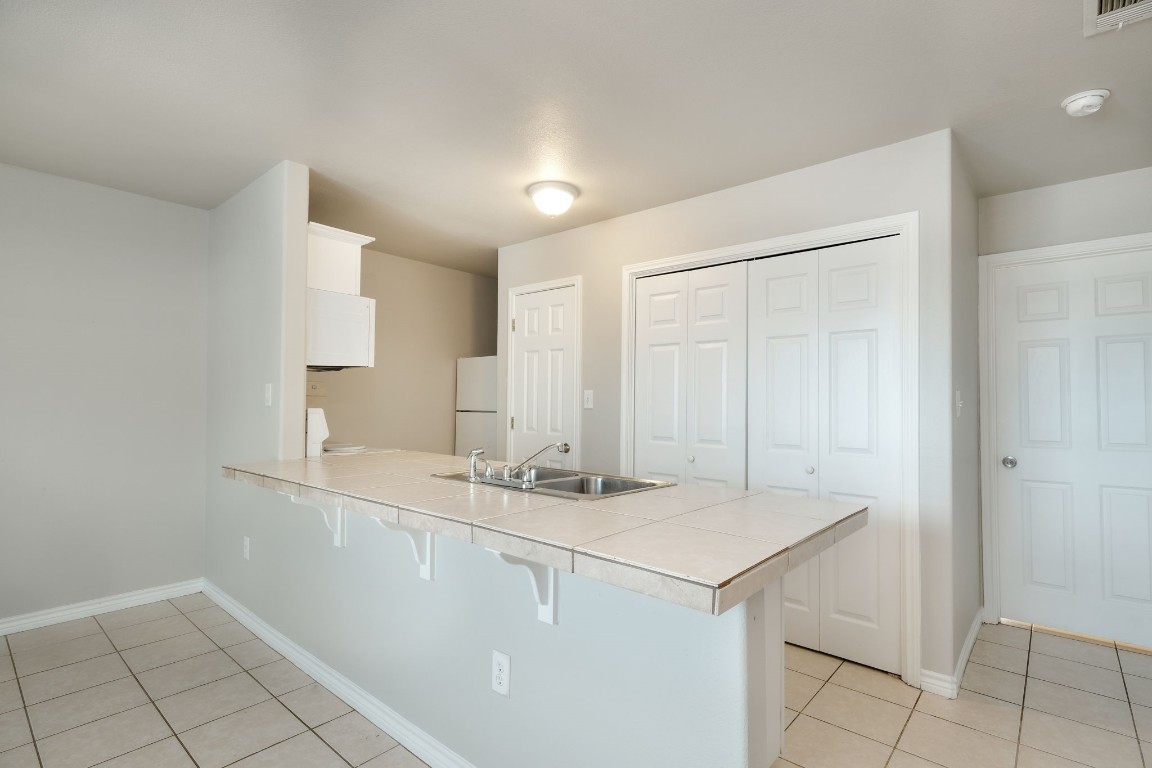 107 Castleberry Court, Unit C Bertram, TX 78605 - Photo 6 of 14 a bathroom with a sink a vanity and a mirror