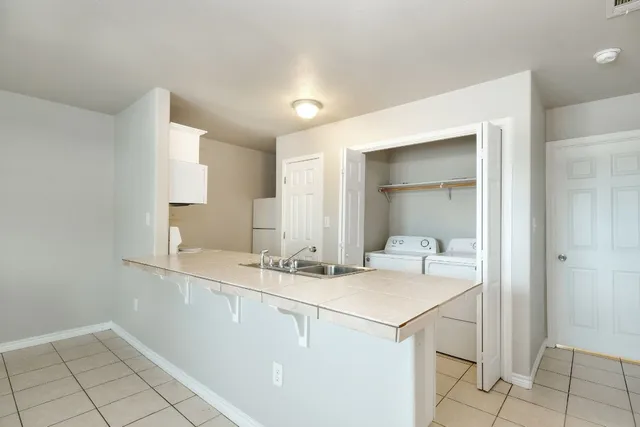 a room with a sink cabinets and utility