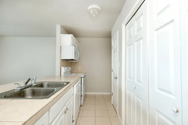 a kitchen with a sink and cabinets
