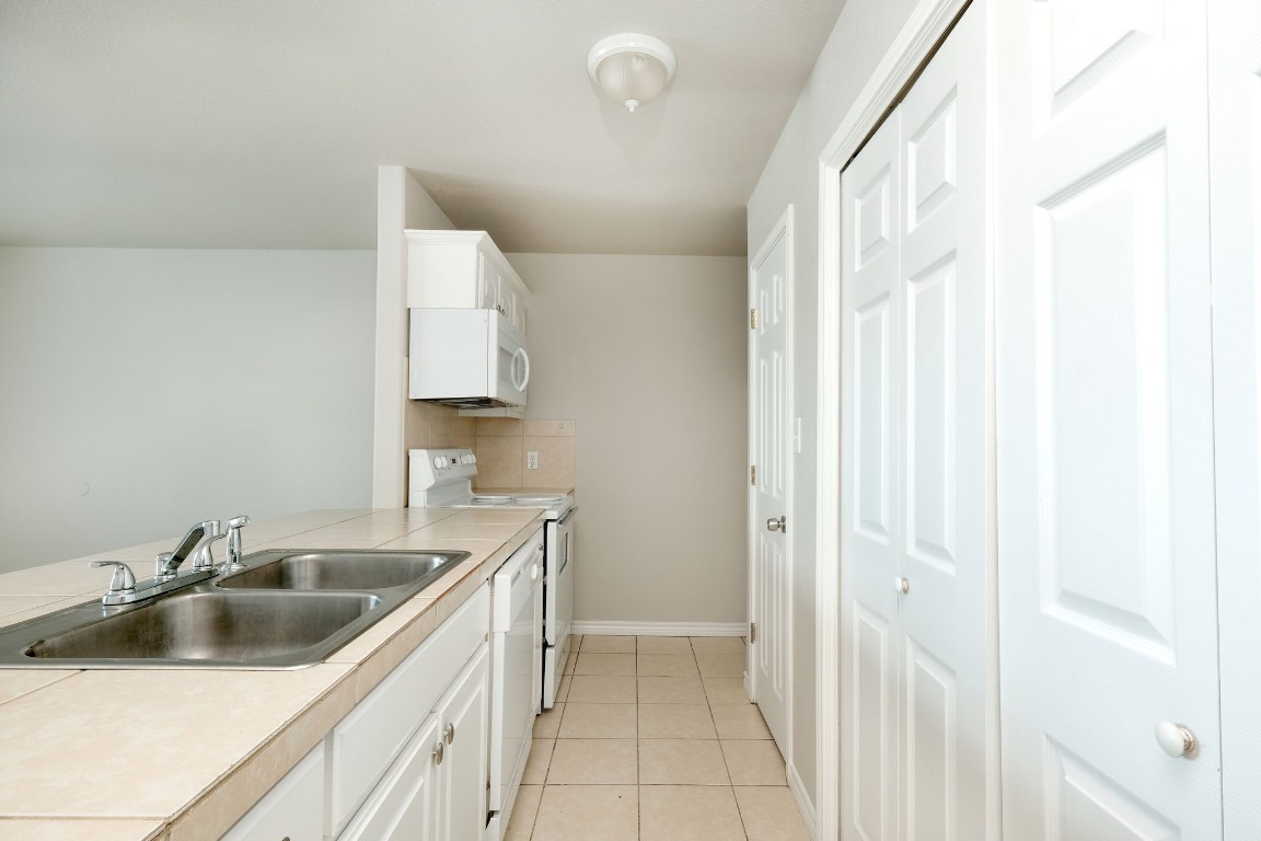 107 Castleberry Court, Unit C Bertram, TX 78605 - Photo 8 of 14 a kitchen with a sink and cabinets