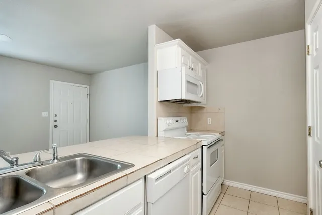 a view white cabinets and a sink