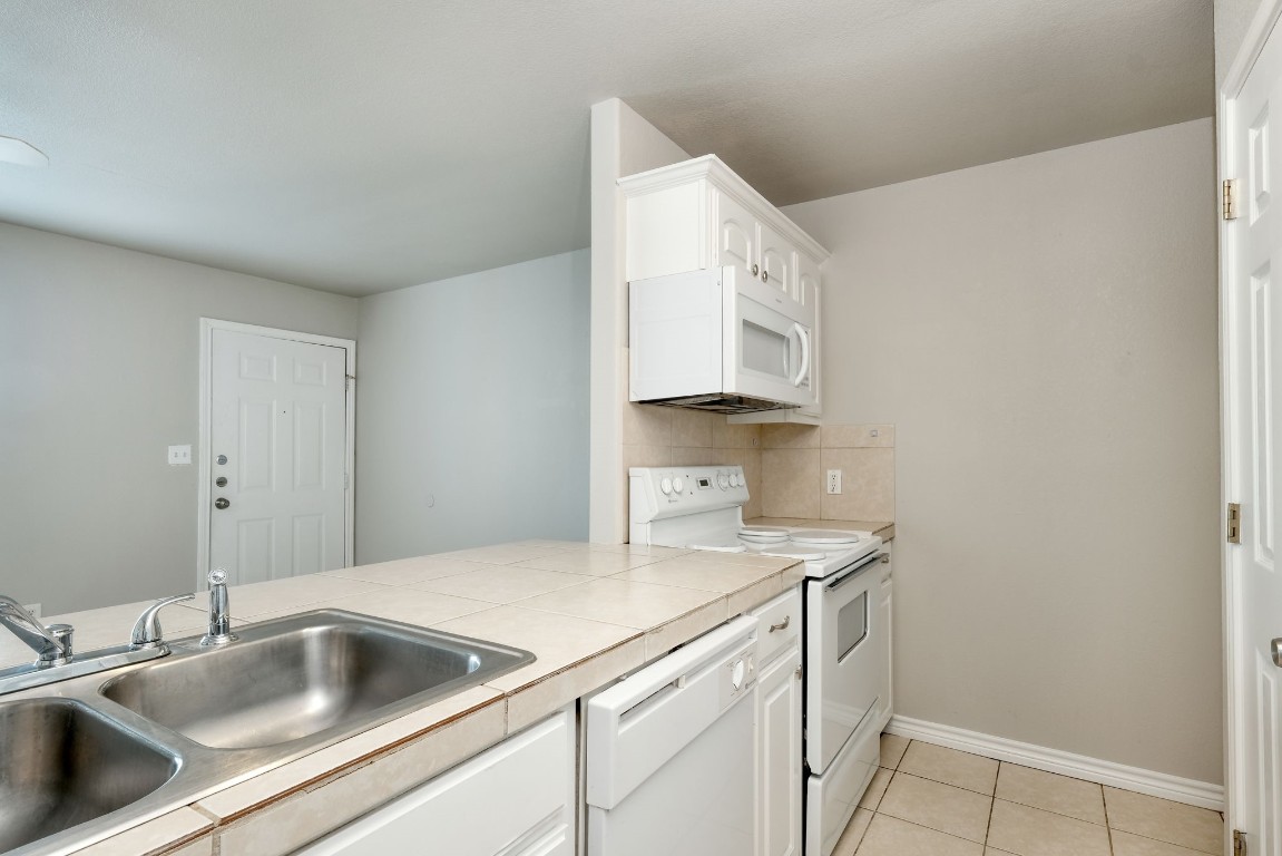 107 Castleberry Court, Unit C Bertram, TX 78605 - Photo 9 of 14 a view white cabinets and a sink