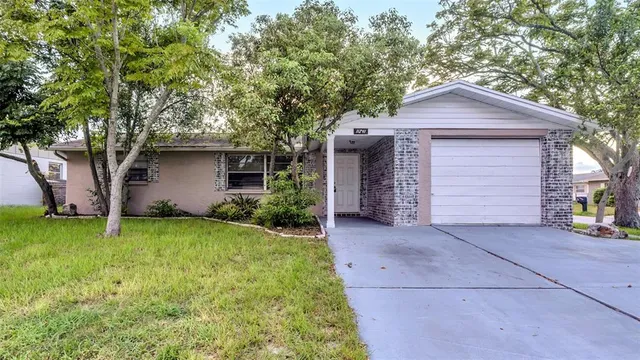 a front view of house with yard and trees