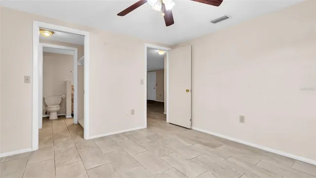 a view of an empty room with window and cabinet