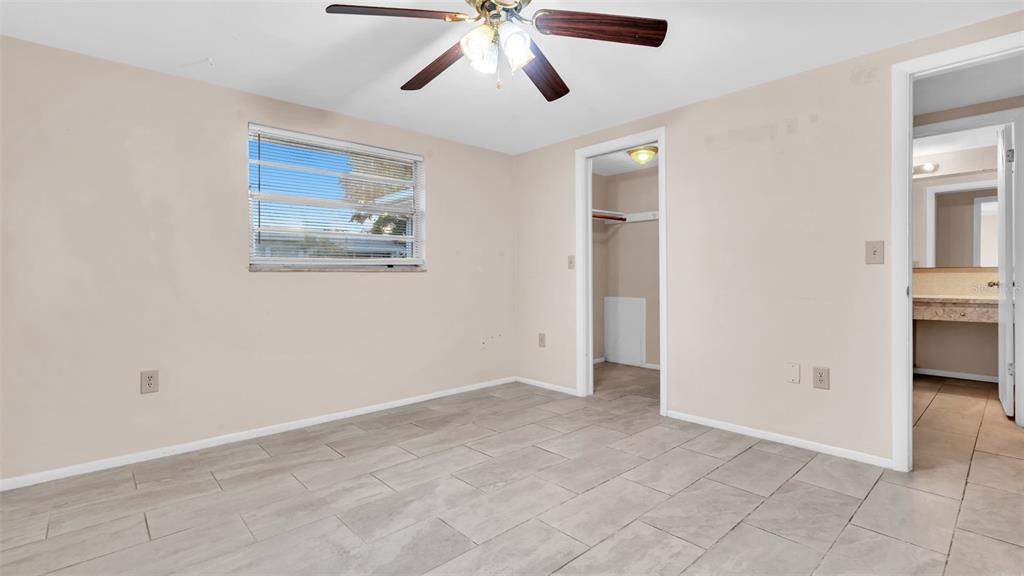 11241 Snyder Avenue Port Richey, FL 34668 - Photo 12 of 24 a view of an empty room with window and cabinet