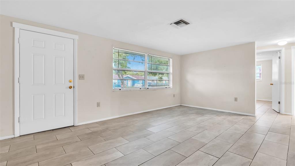 11241 Snyder Avenue Port Richey, FL 34668 - Photo 5 of 24 an empty room with windows