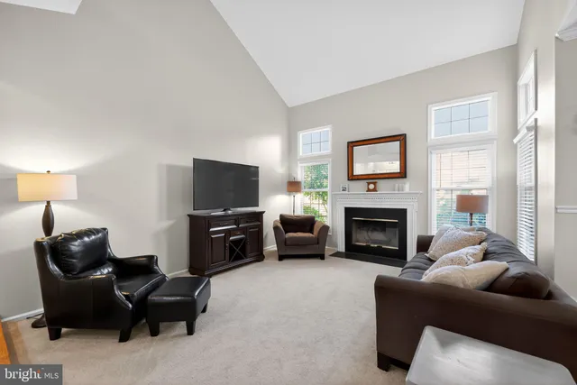 a living room with furniture flat screen tv and a fireplace
