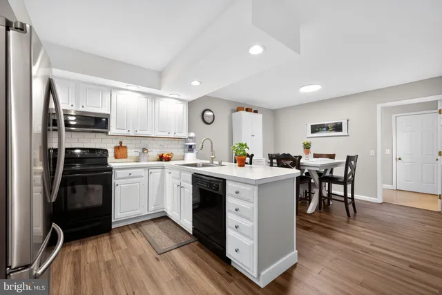 a kitchen with cabinets and stainless steel appliances