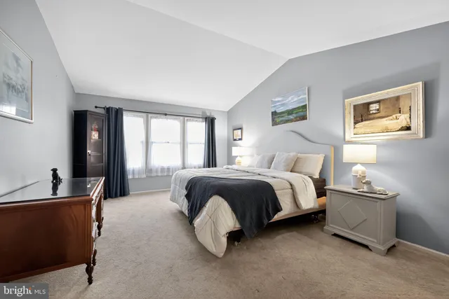 a spacious bedroom with a bed and a couch