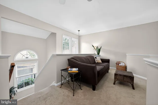 a living room with furniture a window and a flat screen tv