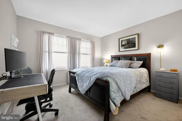 a bedroom with a bed a chair and a desk