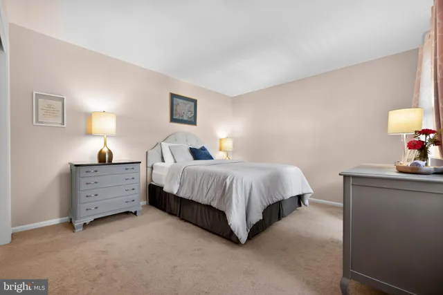 a bedroom with a bed a chair and a desk