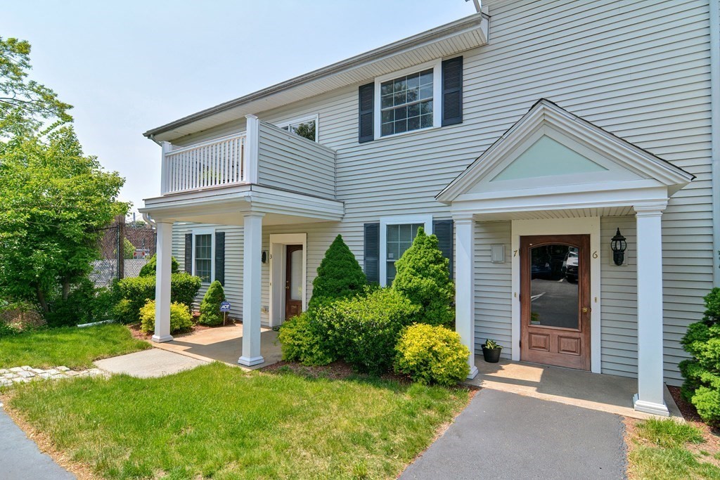 200 Cato Street, Unit 7 Woonsocket, RI 02895 - Photo 1 of 39 a view of a house with a yard and plants