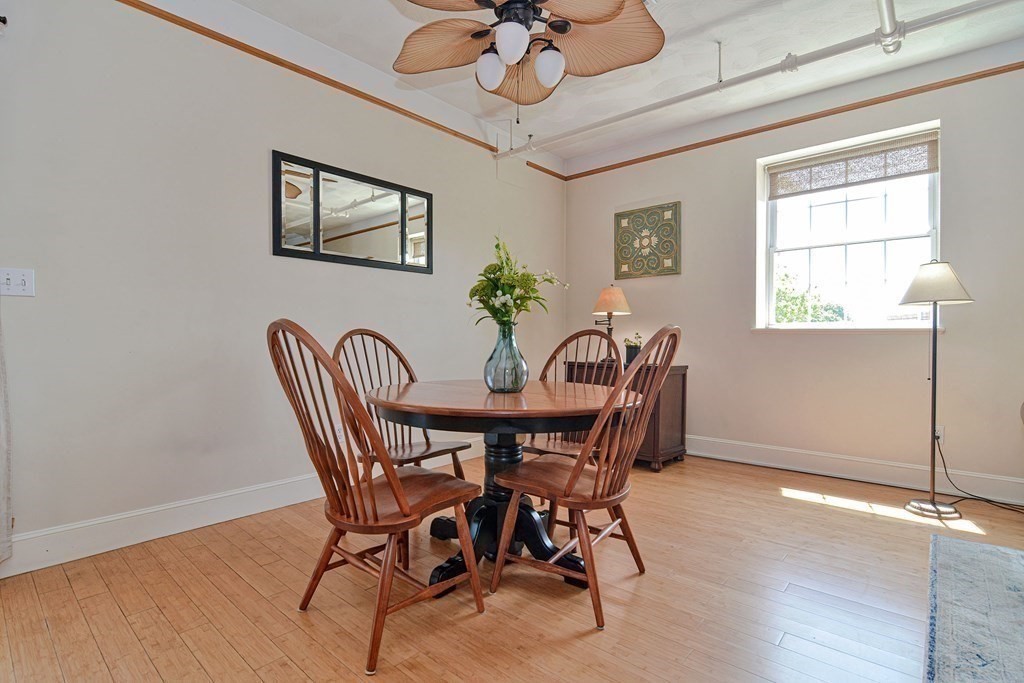 200 Cato Street, Unit 7 Woonsocket, RI 02895 - Photo 12 of 39 a view of a dining room with furniture window and wooden floor