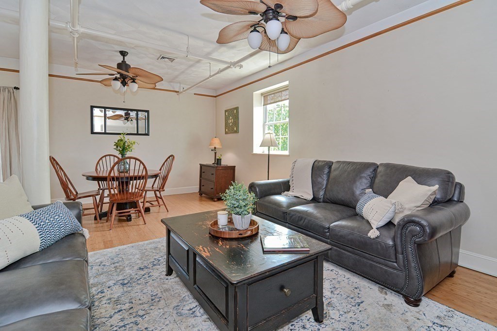 200 Cato Street, Unit 7 Woonsocket, RI 02895 - Photo 18 of 39 a living room with furniture a chandelier and a dining room