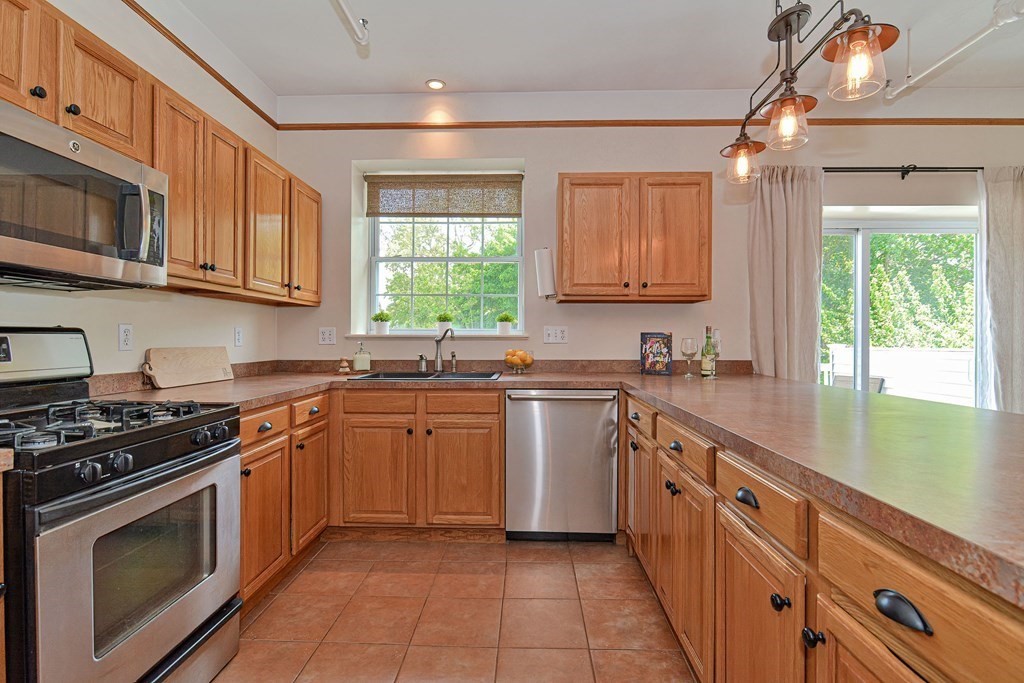 200 Cato Street, Unit 7 Woonsocket, RI 02895 - Photo 2 of 39 a kitchen with stainless steel appliances granite countertop a stove a sink and a microwave