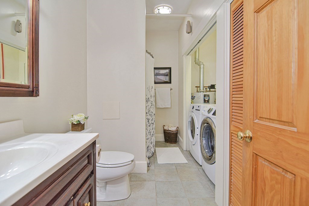 200 Cato Street, Unit 7 Woonsocket, RI 02895 - Photo 21 of 39 a bathroom with a sink a washer and dryer