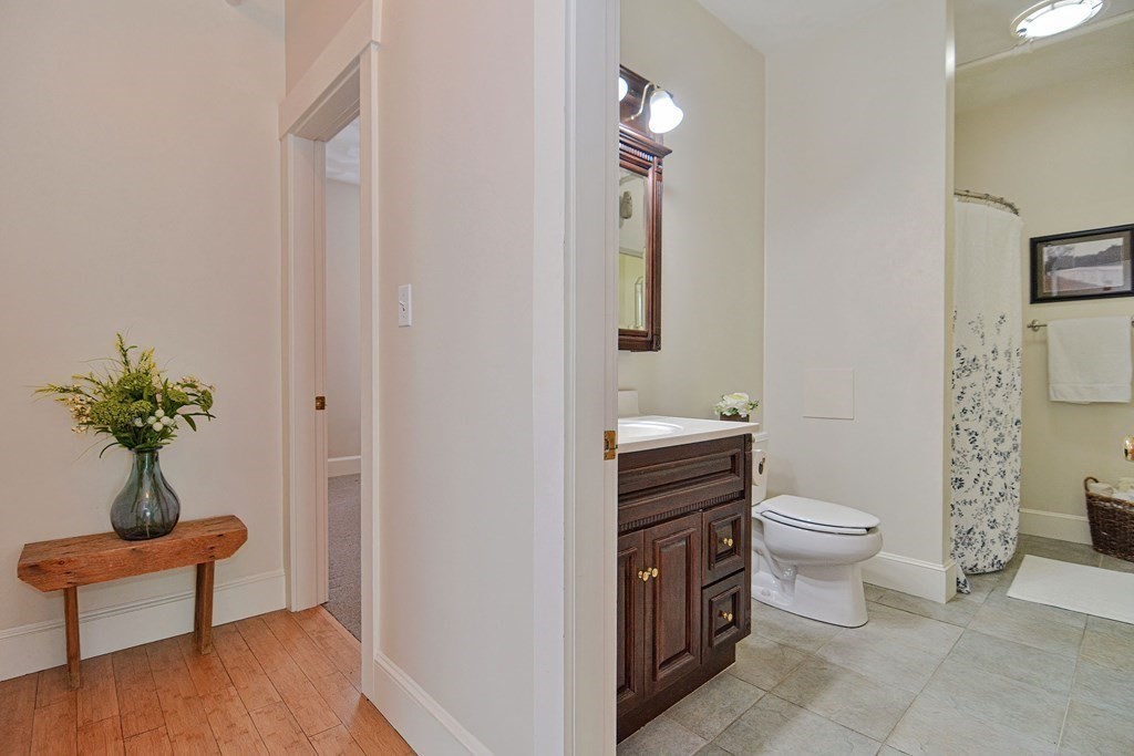 200 Cato Street, Unit 7 Woonsocket, RI 02895 - Photo 22 of 39 a bathroom with a toilet a sink and a mirror