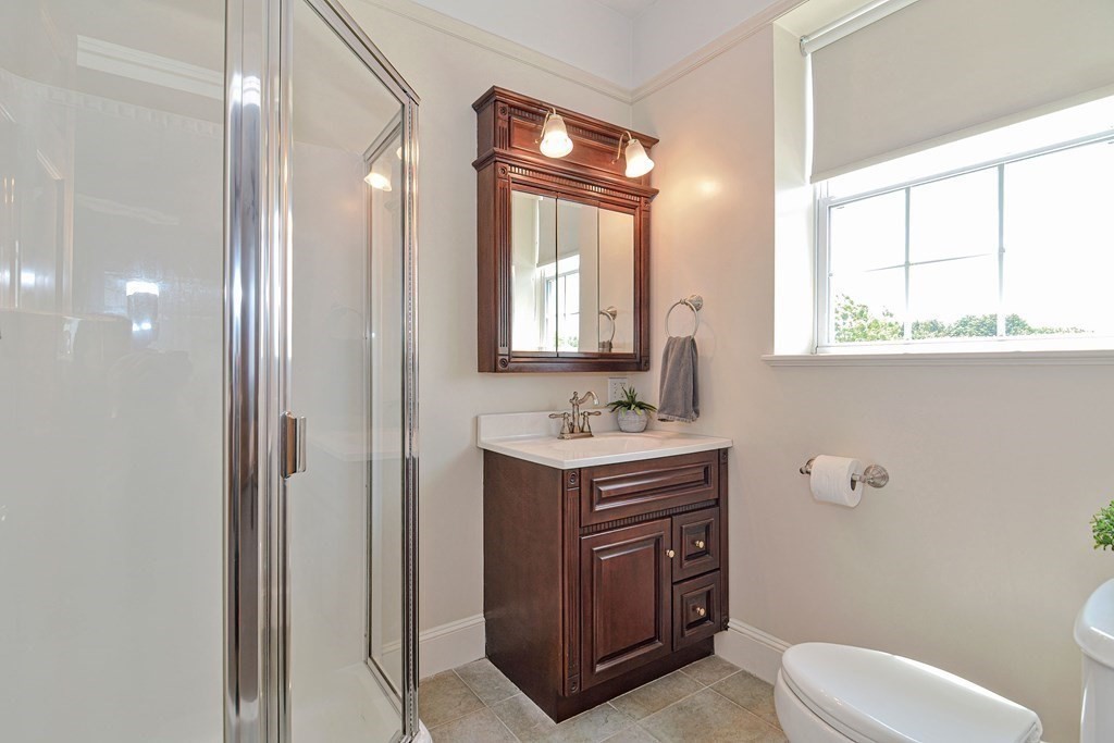 200 Cato Street, Unit 7 Woonsocket, RI 02895 - Photo 29 of 39 a bathroom with a toilet sink and mirror