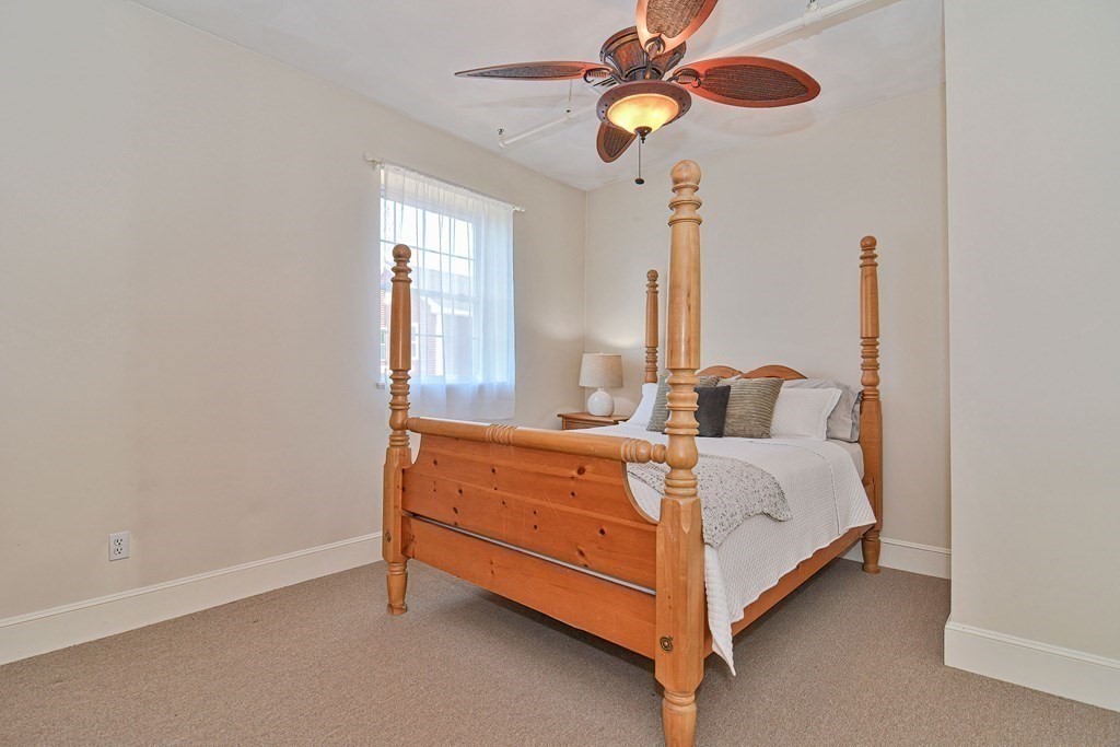 200 Cato Street, Unit 7 Woonsocket, RI 02895 - Photo 31 of 39 a bedroom with a bed and a chandelier