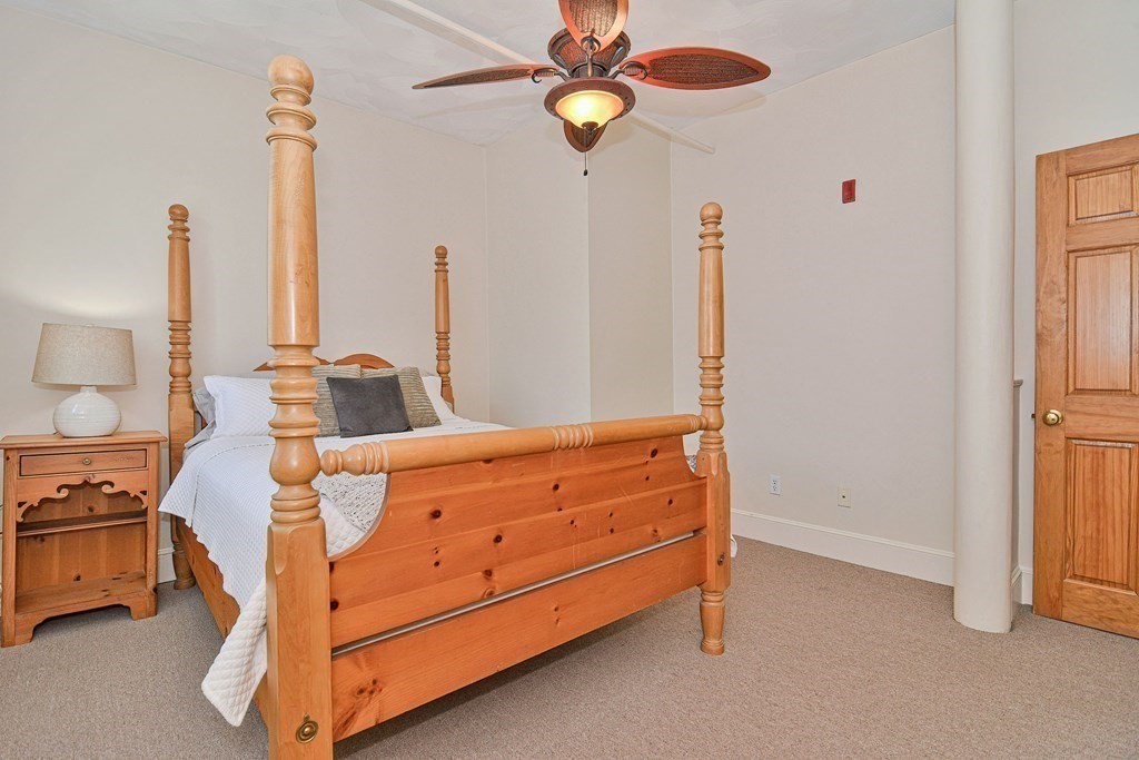 200 Cato Street, Unit 7 Woonsocket, RI 02895 - Photo 32 of 39 a bedroom with a bed and a chandelier